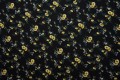 Tkanina wiskozowa - żółte stokrotki na czarnym tle