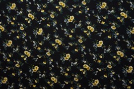 Tkanina wiskozowa - żółte stokrotki na czarnym tle