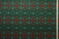 Tkanina świąteczna - czerwone śnieżynki na zielonym tle