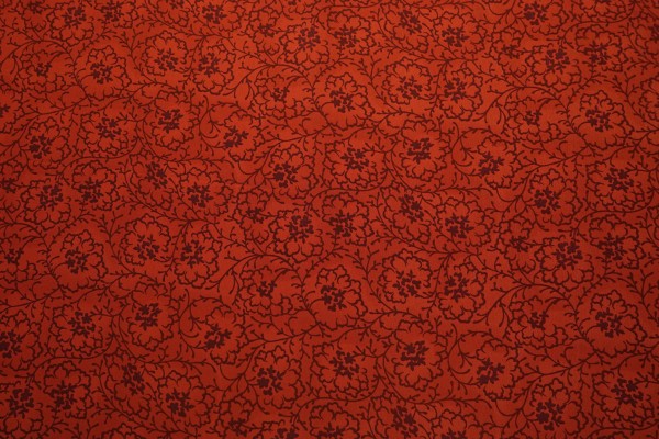 Tkanina sukienkowa w ciemnopomarańczowy wzór