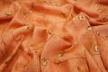 Tkanina sukienkowa - gałązki na łososiowym tle
